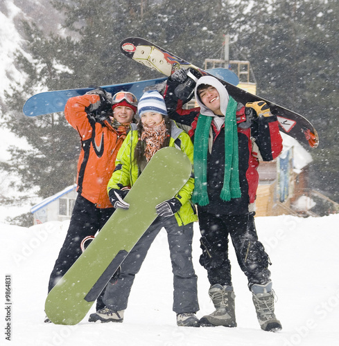Happy snowboarding team in winter mountains, health lifestyle
