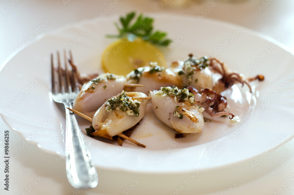 grilled squid stuffed with ham and cheese close up
