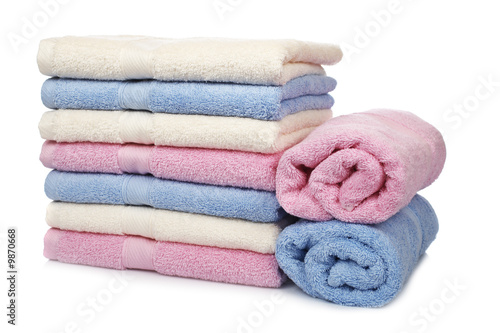 Multicolored towels stacked with soft shadow on white background