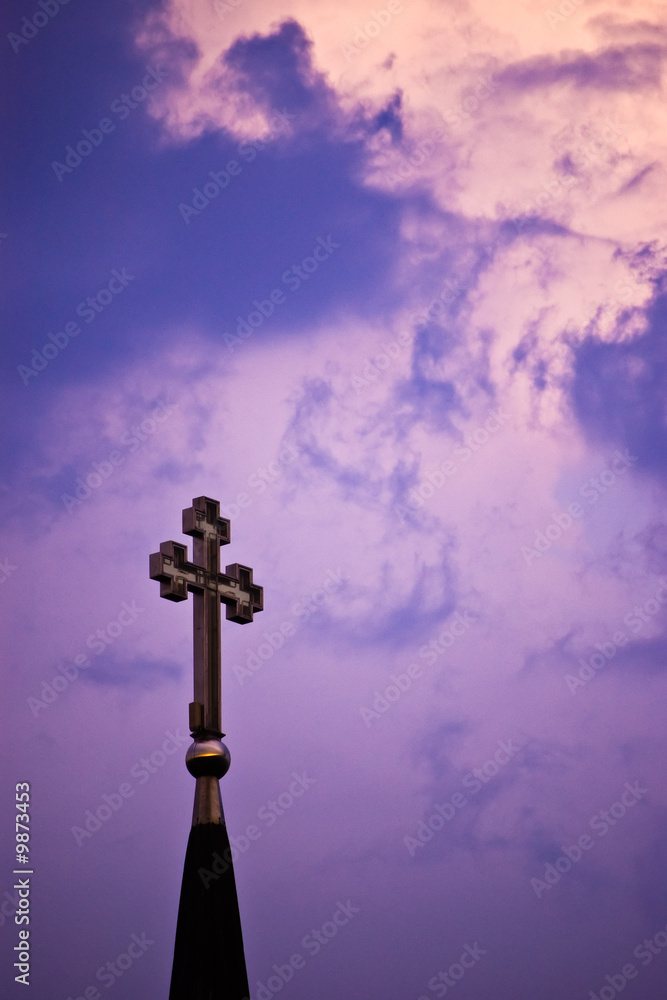 cross on cloudy purple sky