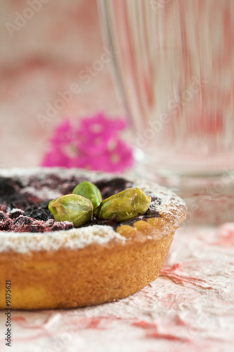 Delicious small tartelette with blueberry and pistachionuts photo