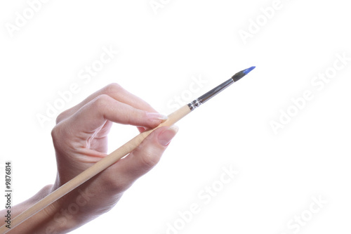 Brush with blue color in hand isolated on white