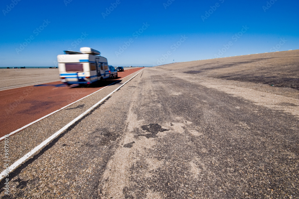 Caravan on wide-angle road.