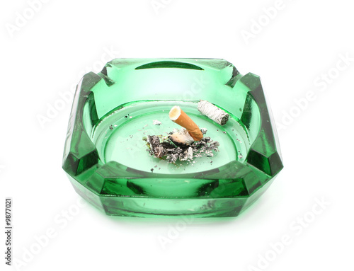 cigarette in green ashtray isolated on white