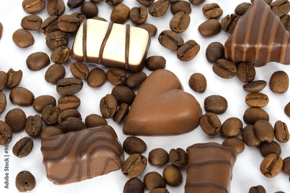 Fototapeta premium Coffee beans and chocolate candies on white background