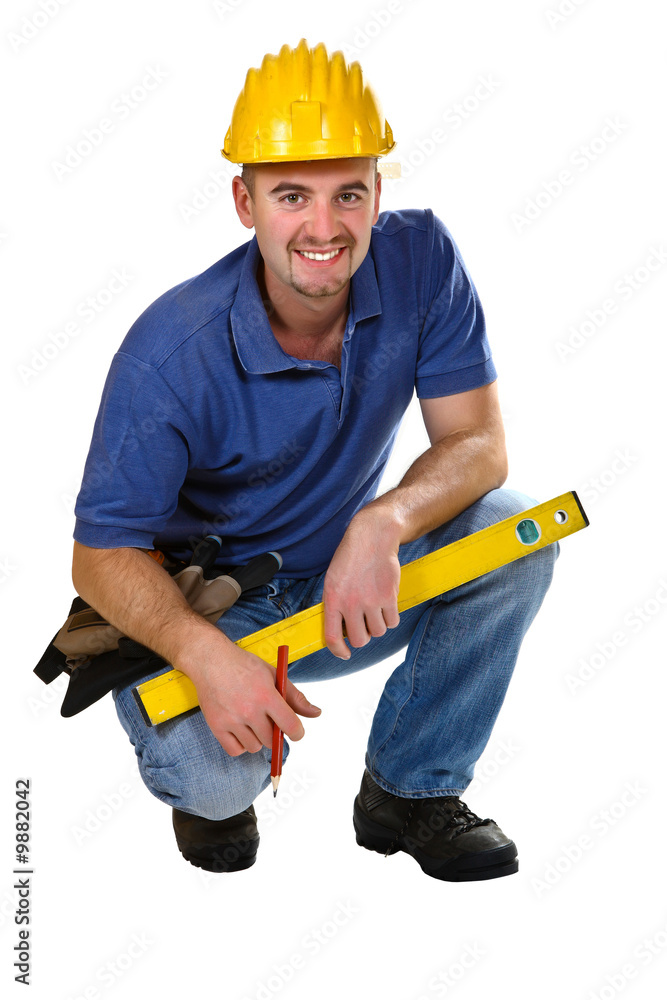 young friendly crouch manual worker isolated on white young friendly crouch manual worker isolated on white