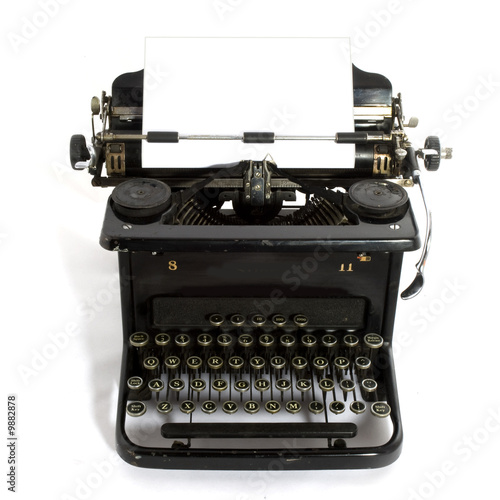 black old-fashioned typewriter with white paper for your text