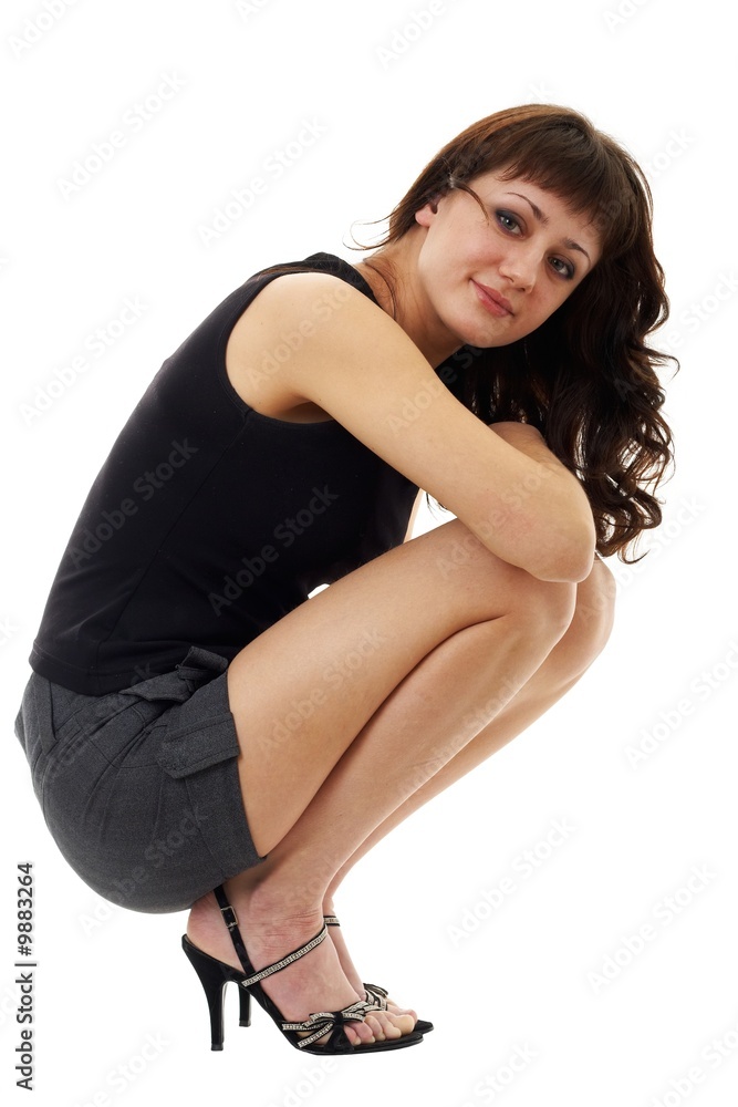 Fototapeta premium young woman sitting against isolated white background