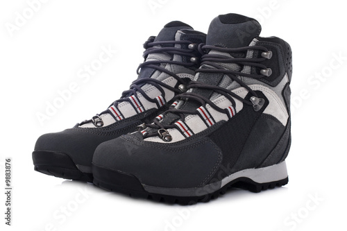 A pair of hiking boots with soft shadow on white background