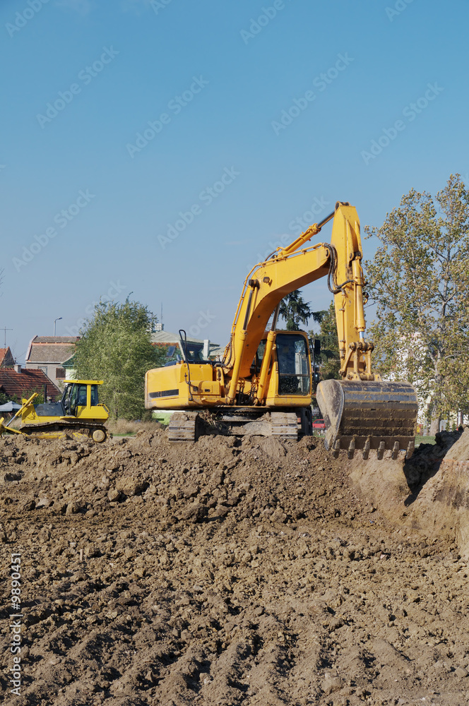 Working with excavator on yellow ground Working with excavator on yellow ground