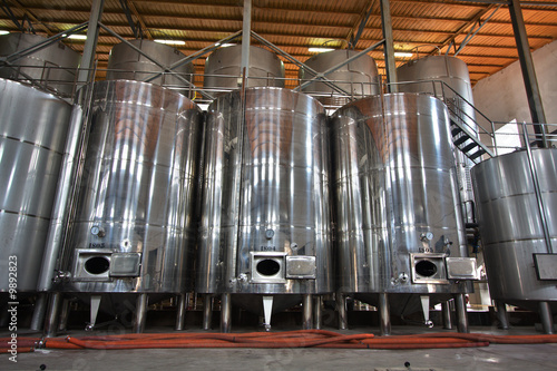 Vino fermentando en enormes tinas en una bodega en España photo