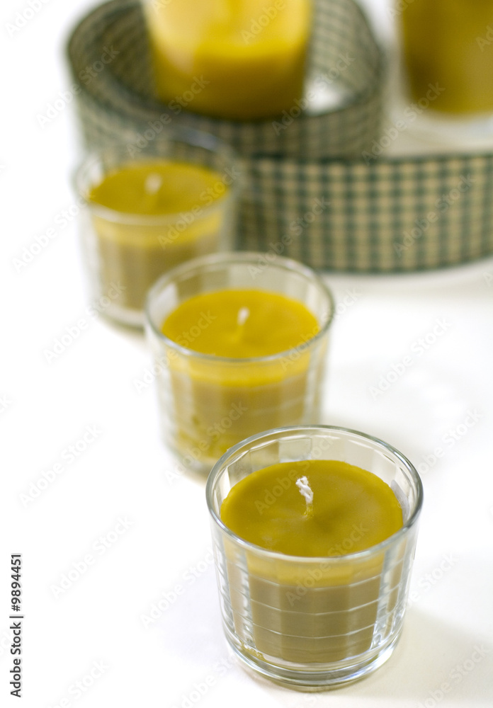 five yellow candles and green ribbon five yellow candles and green ribbon