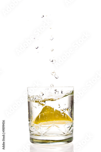Lemon splashing in glass isolated on white background