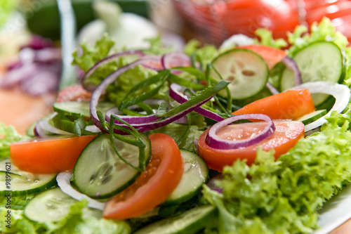 Fresh salad with onion, tomato and basil