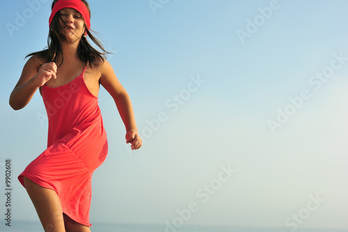 Young girl in red dress dan...