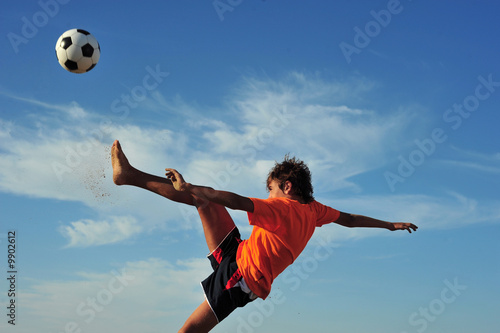 Young boy playing football - low angle virw