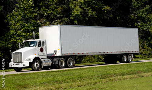 A 18-wheel truck on a highway,