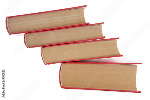 Tower of books about to fall on a white background.