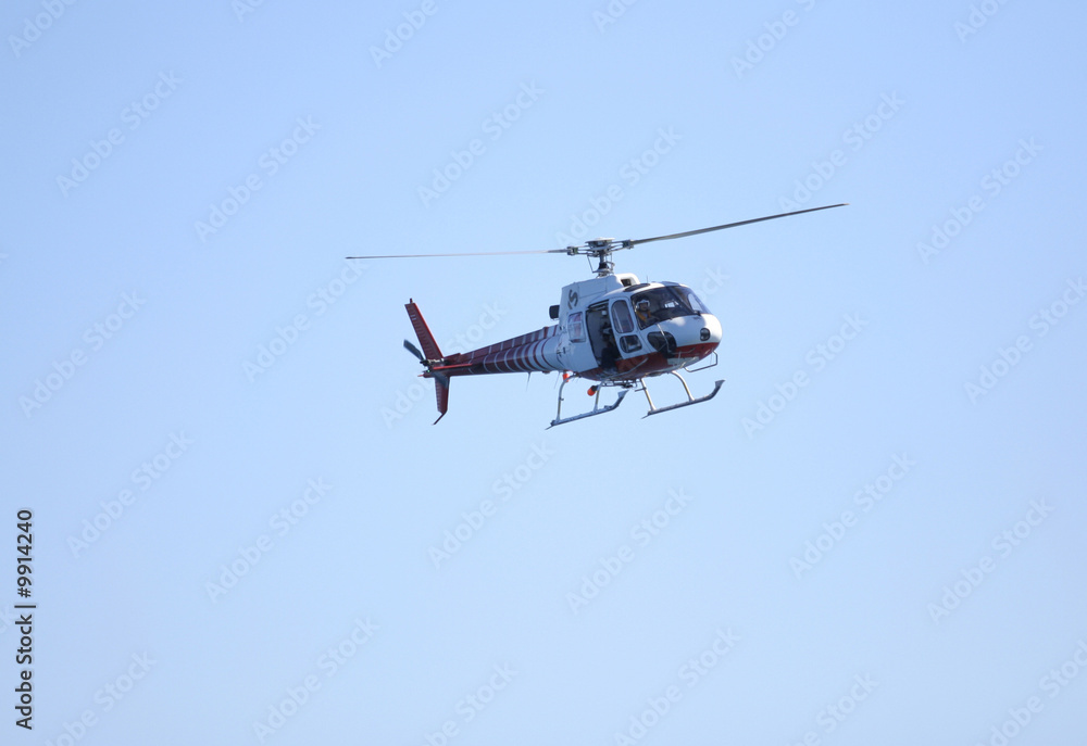 TV-news helicopter in flight with a cameraman shooting