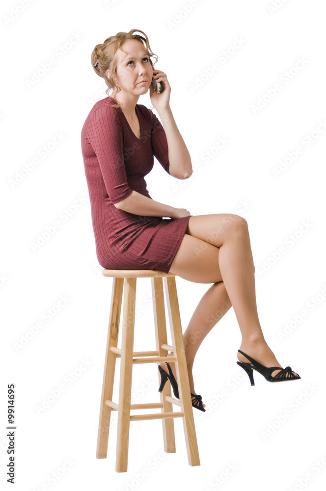 Young woman looks unhappy talking on the phone. Young woman looks unhappy talking on the phone.