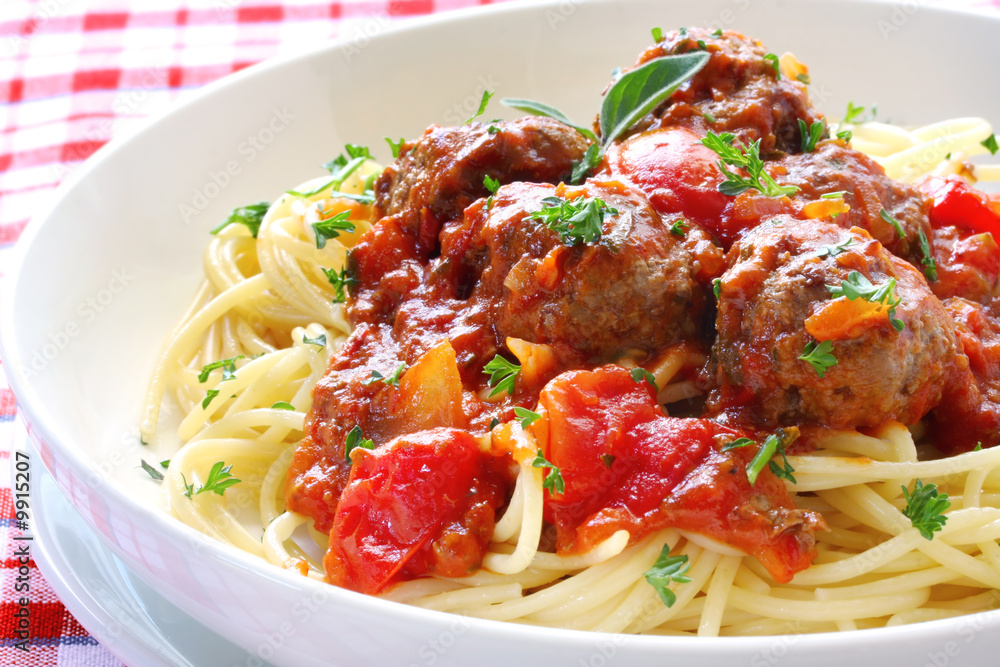 Bowl of spaghetti and meatballs, in a tomato sauce. Bowl of spaghetti and meatballs, in a tomato sauce.