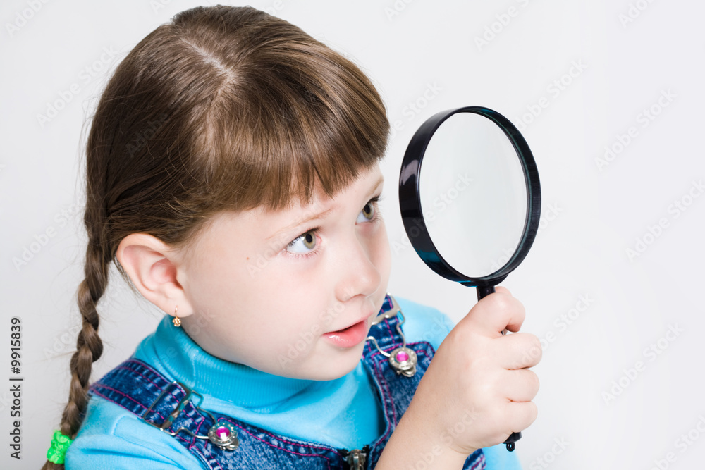 Close-up of small girl holding looking glass in hand Close-up of small girl holding looking glass in hand