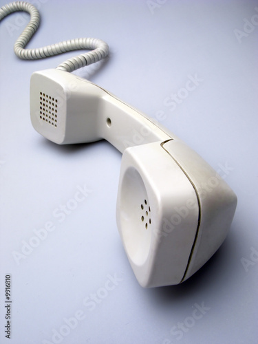 old telephone receiver on  light background
