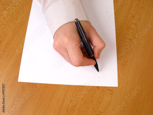 Young businessman writing, closeup