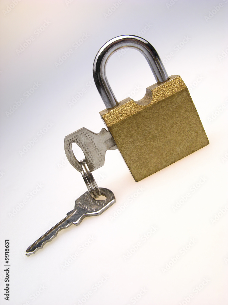 closed padlock with inserted keys on light background closed padlock with inserted keys on light background
