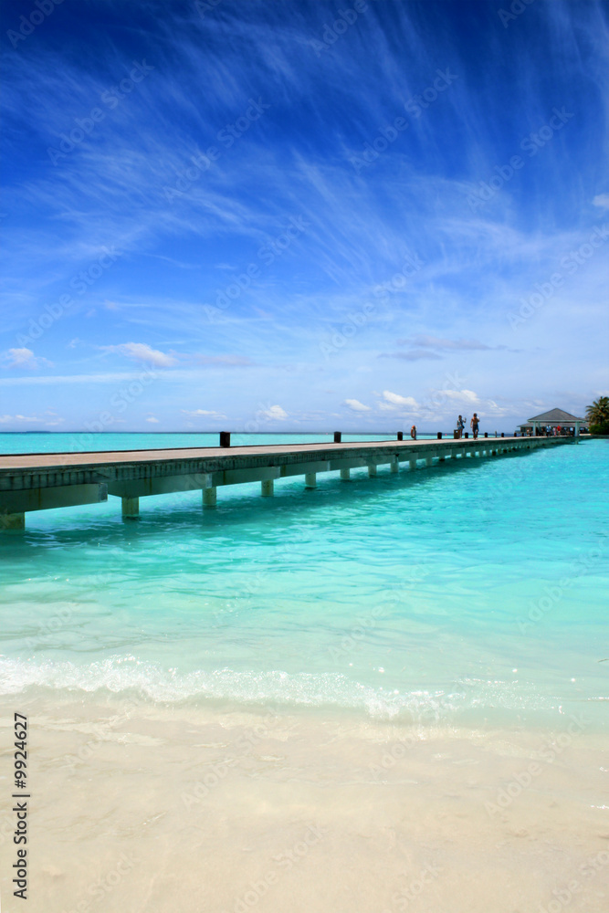 Wooden jetty on over the beautiful Maldivian beach