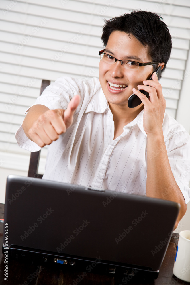 An asian entrepreneur businessman giving a thumbs up An asian entrepreneur businessman giving a thumbs up