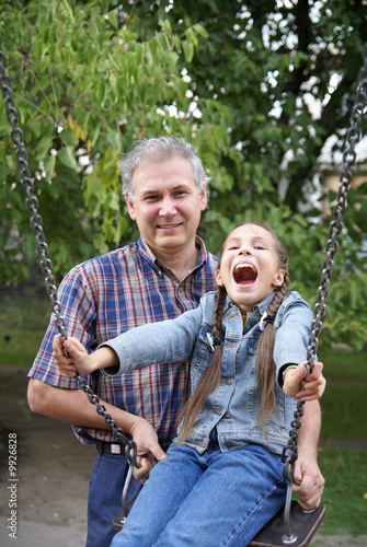 Cheerful father and daughter having fun on playground outdoors