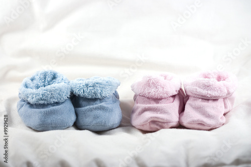 A pair of pink and a pair of blue of cute baby shoes