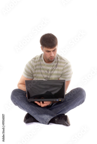 Contemporary looking guy working with laptop, isolated