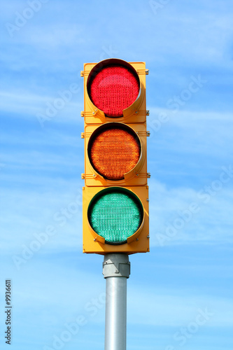 Traffic signal light against blue sky