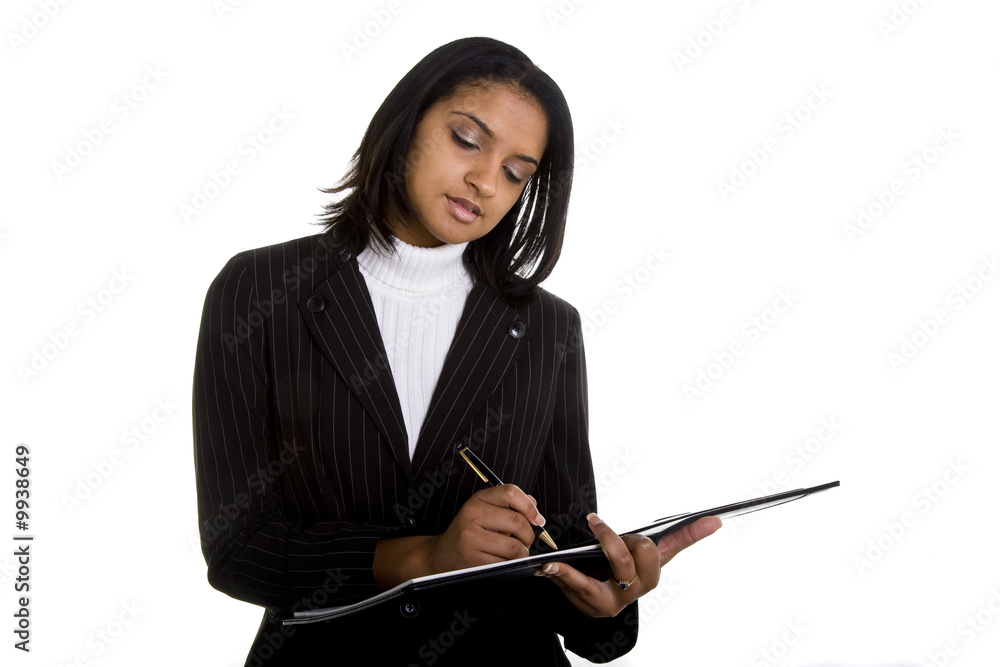 A woman in a business suit writing in a notebook A woman in a business suit writing in a notebook