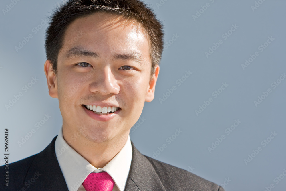 Good looking asian business man standing with formal suit. Good looking asian business man standing with formal suit.