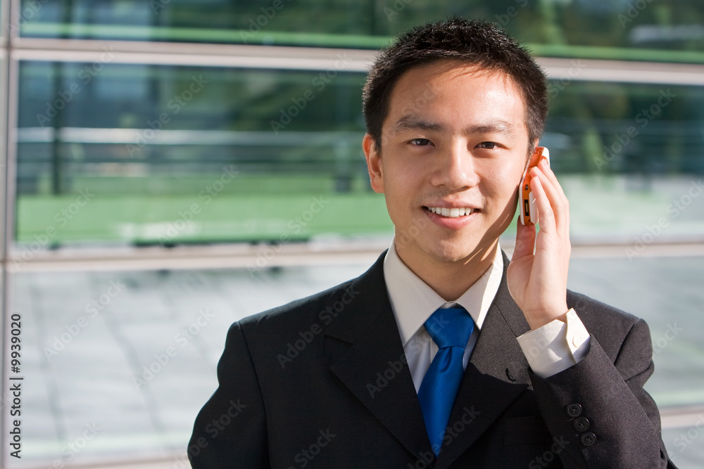 Good looking asian business man with mobile phone. Good looking asian business man with mobile phone.