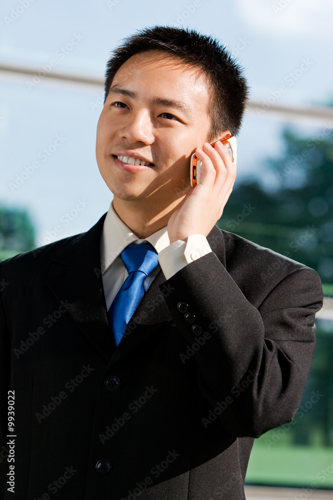 Good looking asian business man with mobile phone. Good looking asian business man with mobile phone.