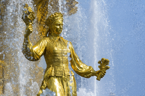 Shining fountain with gold woman's sculpture