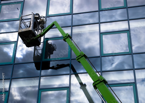 Window cleaner working on a glass facade in a gondola