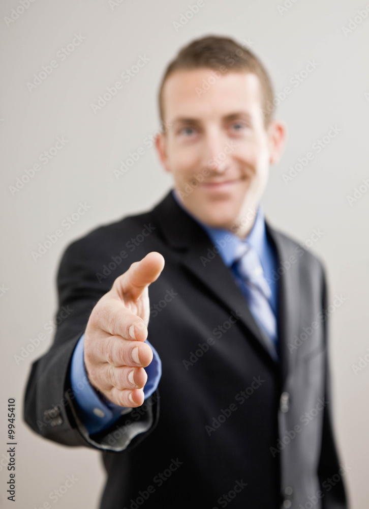 Confident businessman offering hand for handshake Confident businessman offering hand for handshake
