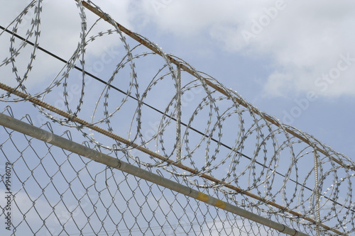 Barbed wire on top of chain linked fence