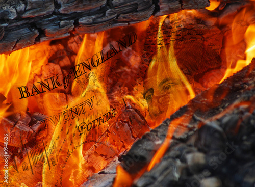 Conceptual image of flames burning pound currency notes