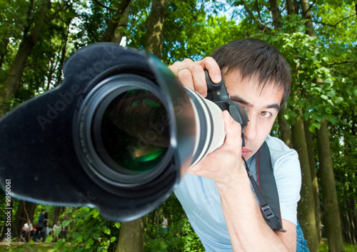 Portrait of the photographer on a background of a wood