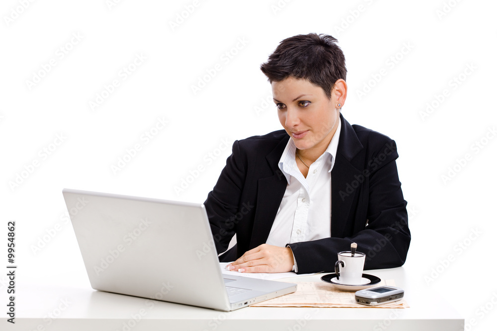 Businesswoman working at desk, isolated on white. Businesswoman working at desk, isolated on white.