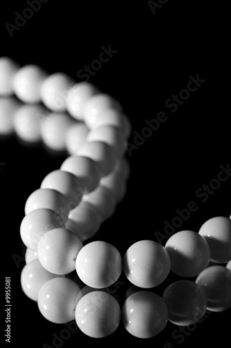 white beads isolated over black