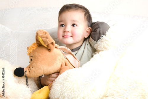 little hapy boy with his toys