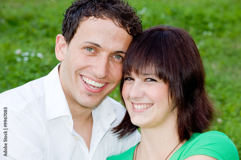 Young, happy and smiling couple in a park. Young, happy and smiling couple in a park.