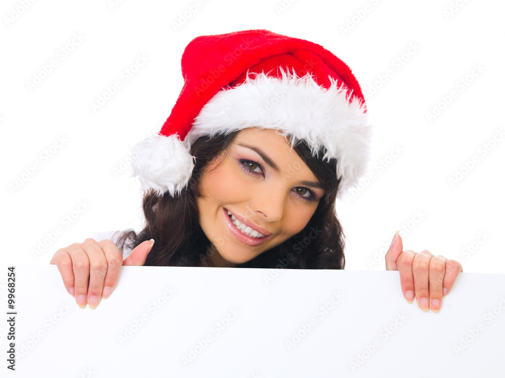Beautiful christmas woman in santa hat holding empty board Beautiful christmas woman in santa hat holding empty board